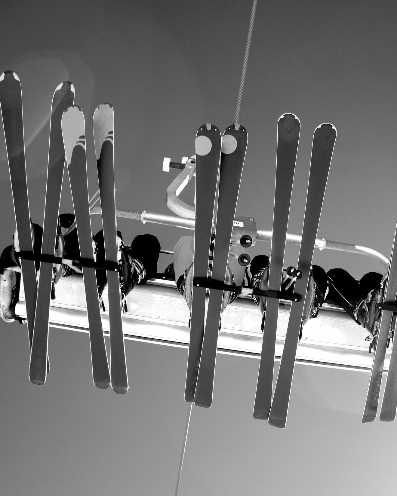 people sitting on a ski lift, taken from underneath