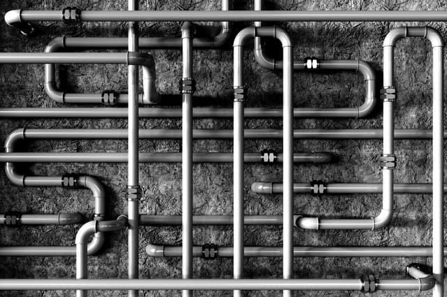 Close up several gas pipelines intersecting and overlapping each other.