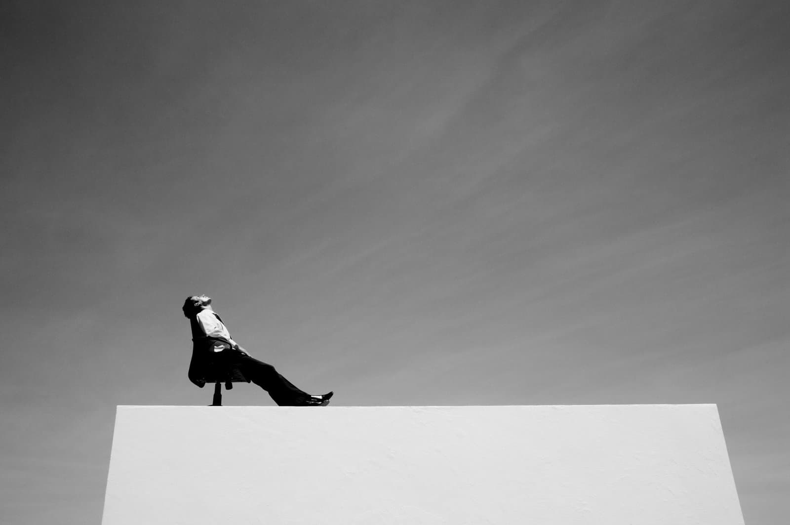 A person sitting on a swivel chairing staring up into the sky