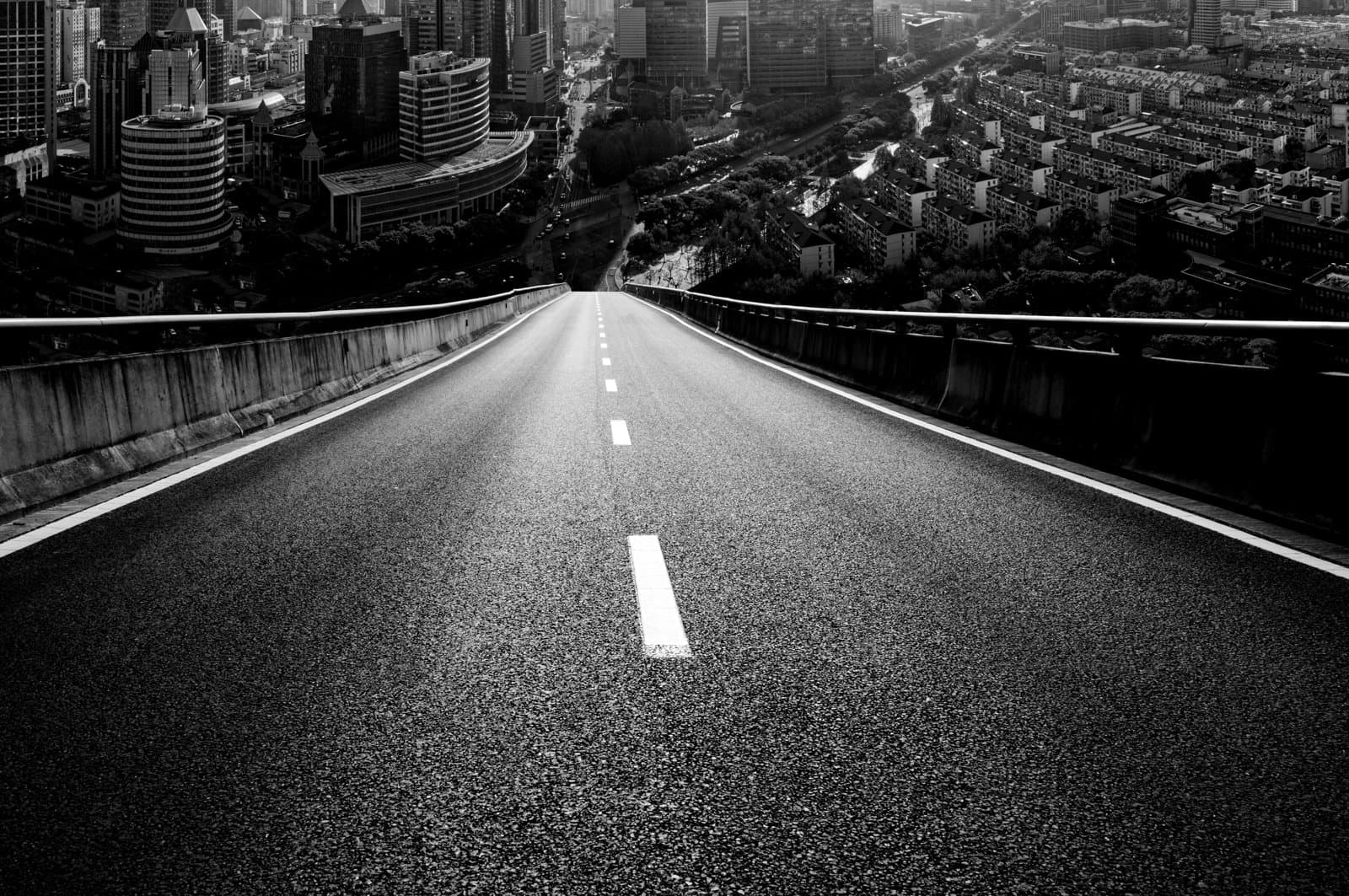Road leading downhill to a city