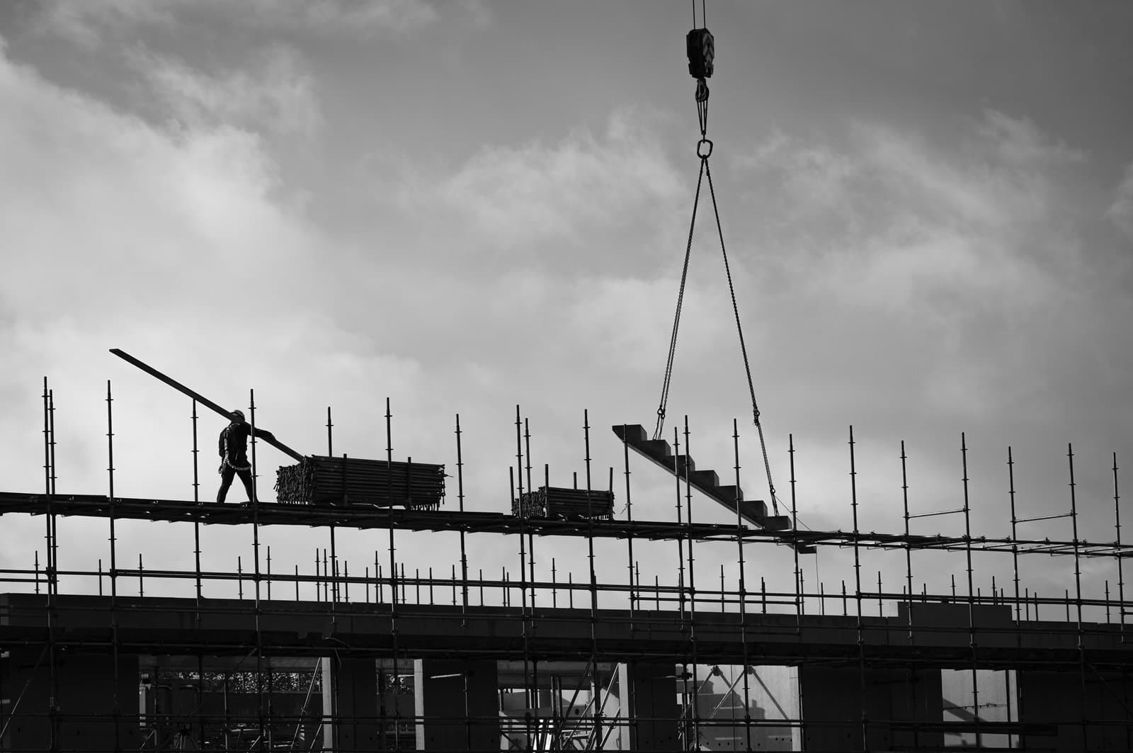 Silhouetted worker on scaffolding