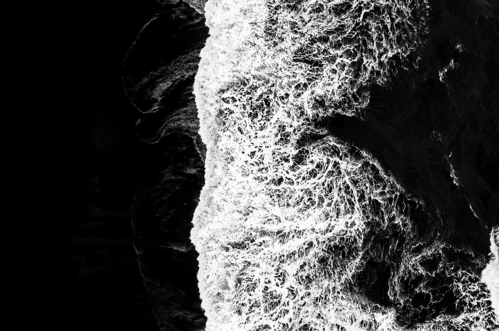 The black sand beach in Iceland. Sea aerial view and top view